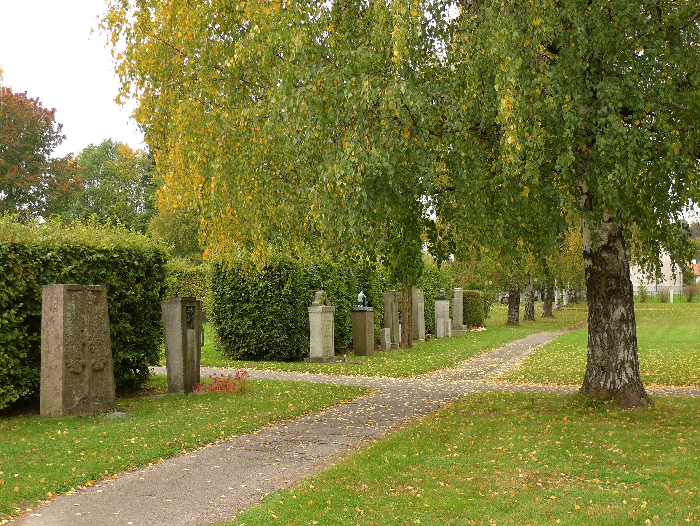 Tønsberg cemetery, pictured with tomb stones and a big tree, was designed by Pål Sæland.