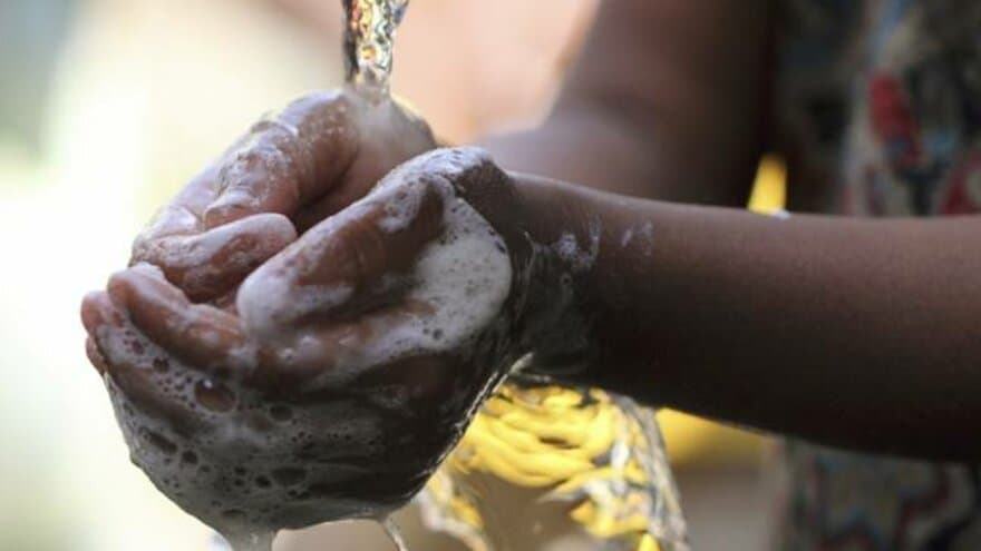 A girl washing her hands during Global Hand-washing Day. 